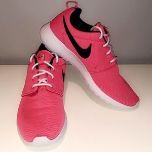 Neon pink Nike running shoes